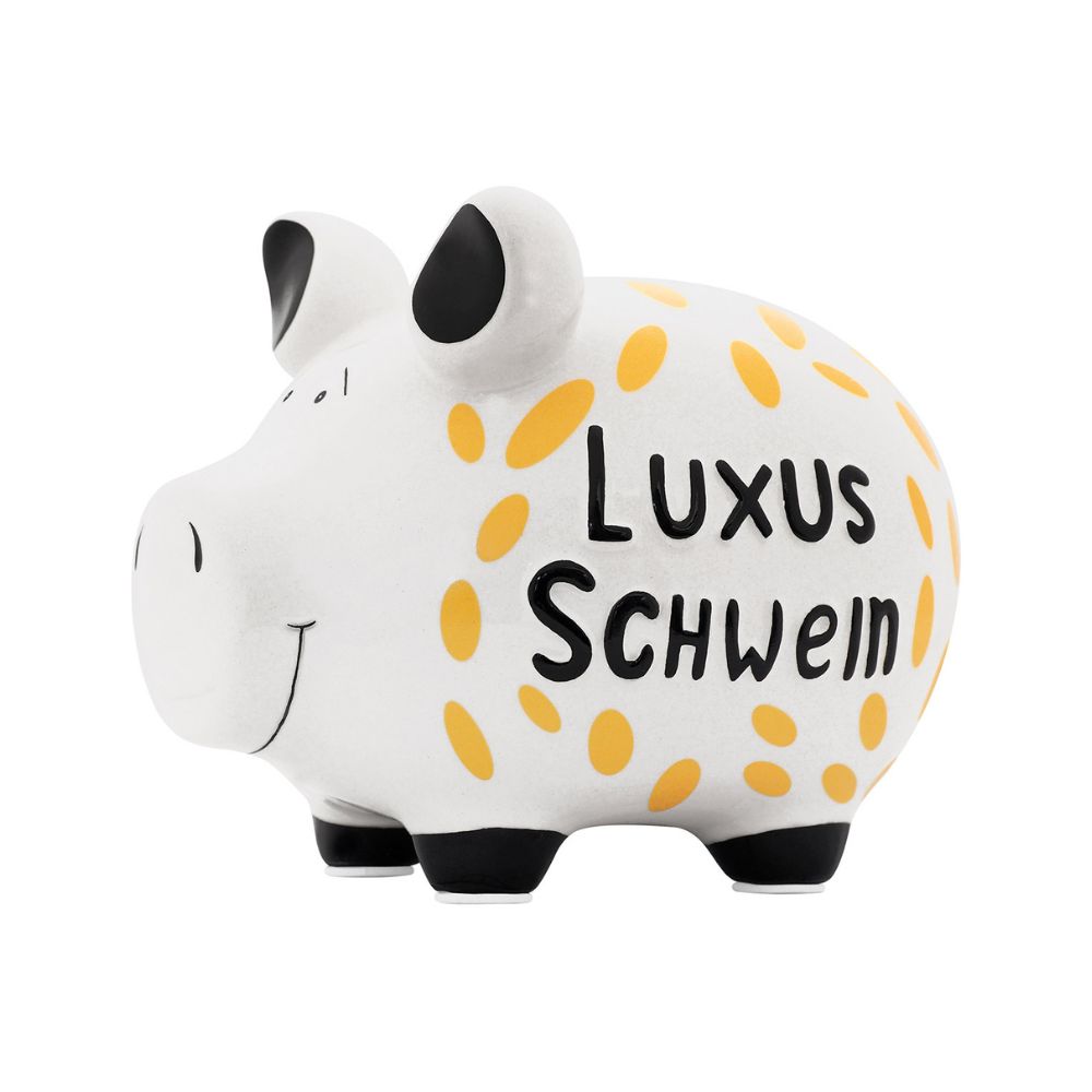 Weißes Sparschwein mit schwarzen Füßen und Ohren und der Schrift "Luxus Schwein" Die Schrift ist umgeben mit goldenen ovalen Formen