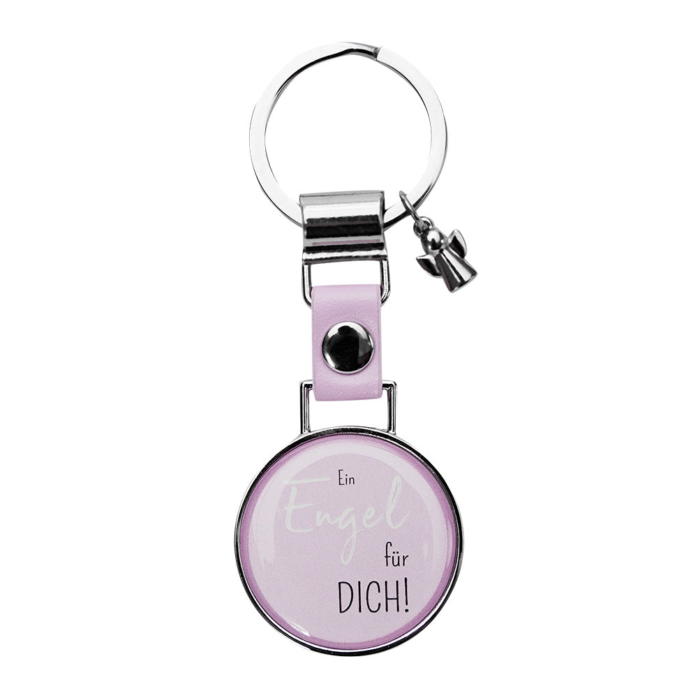 Ring mit Schlüsselanhänger mit einem kleinen Engel und einem runden Symbol in dem steht "Ein Engel für dich!" mit pinkem Hintergrund