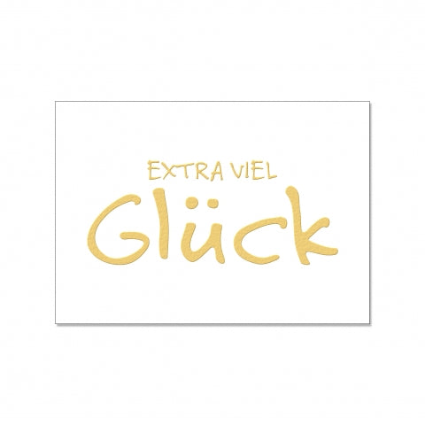 Weiße Postkarte mit der Goldenen Schrift "Extra viel Glück"