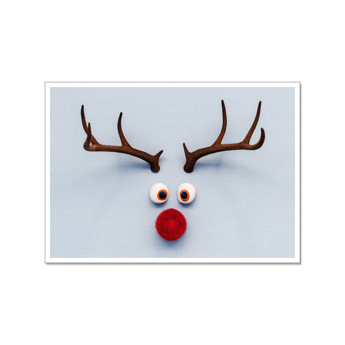 Postkarte mit einem Rudolph Motiv, doch sind nur Hirschhörner, Augen und rote nase auf der Karte zu sehen