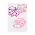 Bunte Donuts mit Glasur auf Geschirrtuch