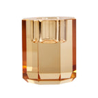 Ein kleiner Dioptrics Kerzenhalter aus Glas in Hellbraun Kristall-Optik, bestehend aus mehreren geometrischen Flächen. Der Kerzenhalter hat eine moderne, facettierte Optik, die das Licht reflektiert