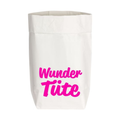 Tüte aus Kraftpapier mit einer aufgedruckten pinken Schrift "Wundertüte" und einem braunen Rand