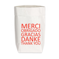 Eine Papiertüte mit dem Spruch ''Merci obrigado Gracias danke thank you'' von 17;30