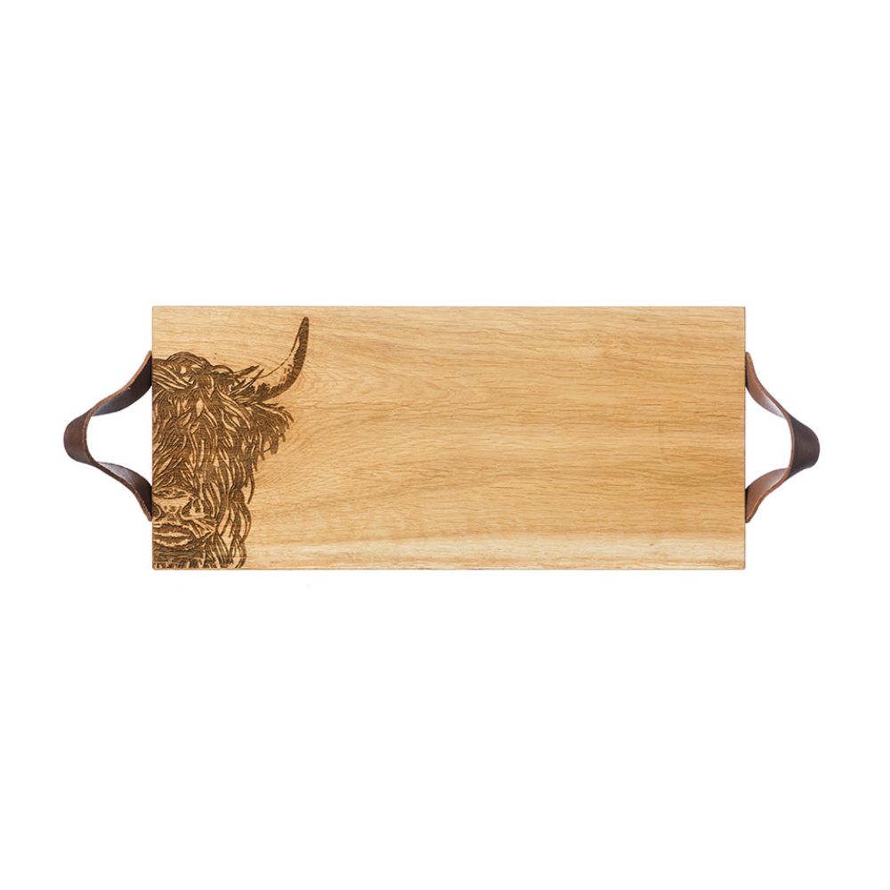 Serviertablett aus schottischer Eiche mit einem eingebrannten Hochlandrind-Motiv und zwei Lederriemen links und rechts