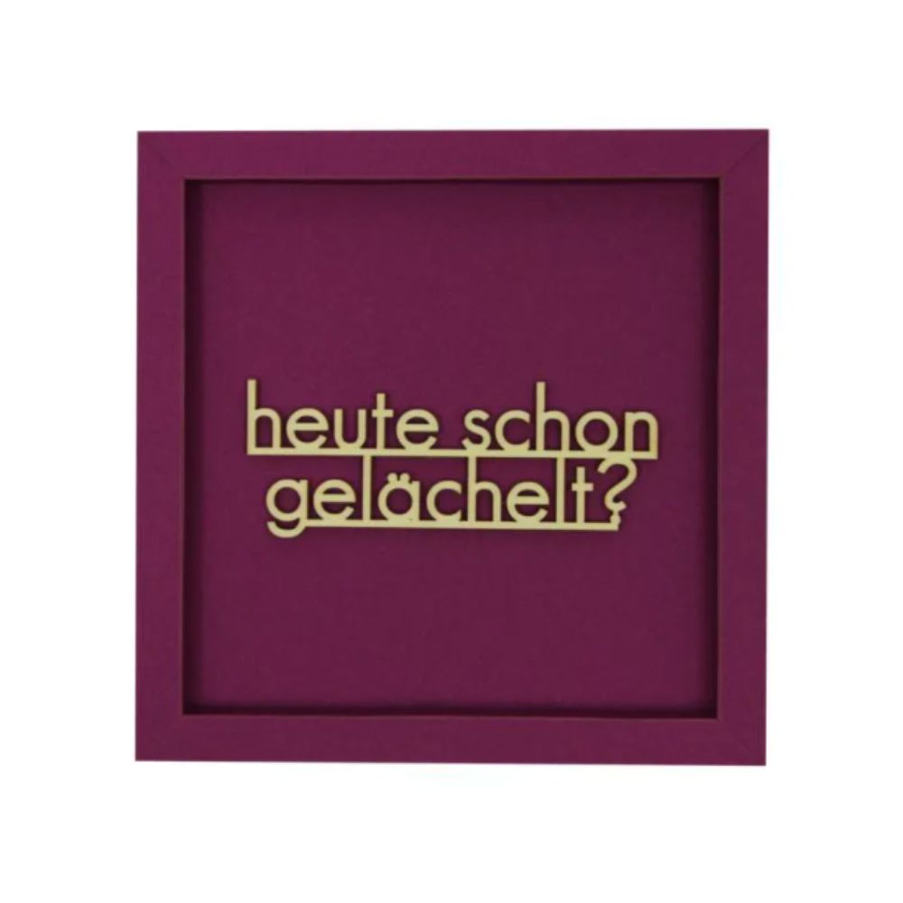 Quadratische Wanddekoration in Aubergine mit dem Spruch "Heute schon gelächelt?"