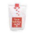 Weiße Wundertüte mit sechs kleinen aufgeklebten roten Herzchen und ein rotes Label mit der Aufschrift "Für die beste Mama der Welt"
