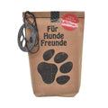 Braune Wundertüte mit schwarzer Schrift „Für Hunde Freunde“ und aufgedruckter schwarzer Pfote. Oben an der Tüte befindet sich ein rundes Filzstück, aus dem eine Pfotenform ausgestanzt ist
