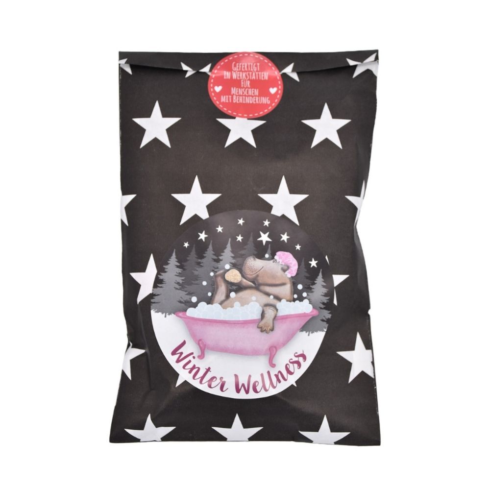 Schwarze Wundertüte mit Weißen Sternen und einem Sticker mit einem Nielpferd, dass in einer Pinken Badewanne badet.