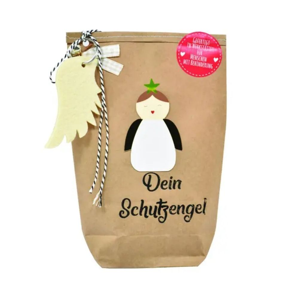 Braune Wundertüte mit einem Aufgeklebten Engel, einem an der Tüte angehangenen Flügel aus Filz als Schlüsselanhänger und der Schrift auf der Tüte "Deine Schutzengel"