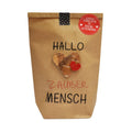 Braune Wundertüte mit der Schrift "Hallo Zauber Mensch" und einem aufgeklebten goldenen Herzen