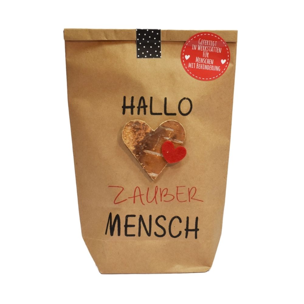 Braune Wundertüte mit der Schrift "Hallo Zauber Mensch" und einem aufgeklebten goldenen Herzen