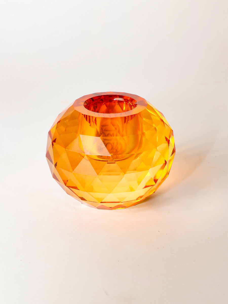 Dioptrischer Kerzenhalter erleuchtet und reflektiert das Licht prismatisch in Bernstein