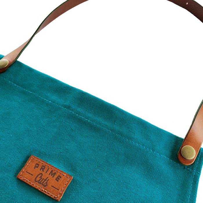 Petrol farbende Küchenschürze aus Baumwolle mit Bauchtasche und Leder-Träger