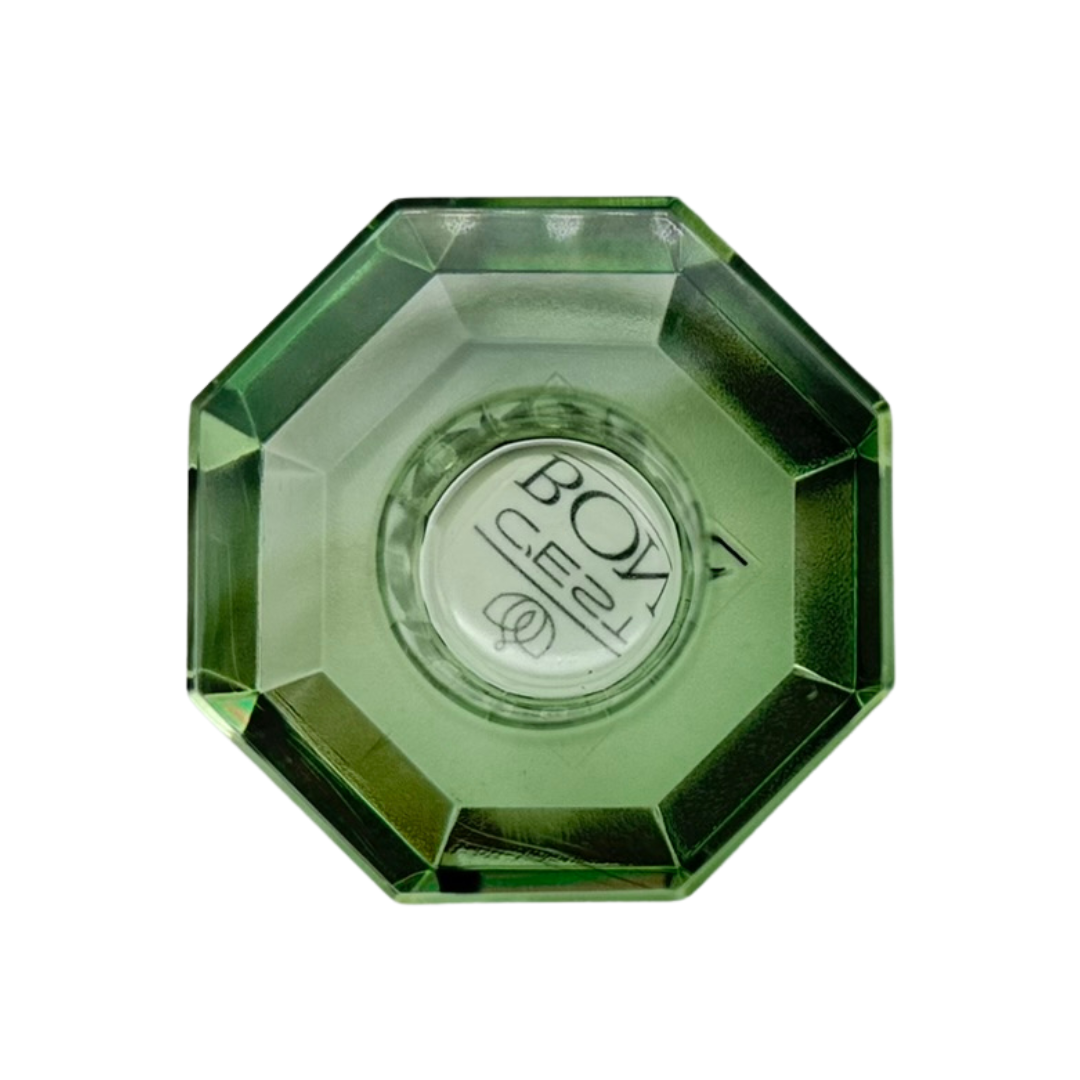 Ein niedriger Kerzenhalter in Olive Kristall-Optik, bestehend aus mehreren geometrischen Flächen. Der Kerzenhalter hat eine moderne, facettierte Optik, die das Licht reflektiert von oben fotografiert