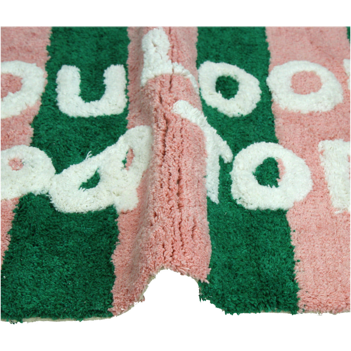 Grün Pink gestreifte Badematte mit der weißen Schrift "You look good today"  Nahaufnahme eines teils gebogenen Badvorlegers